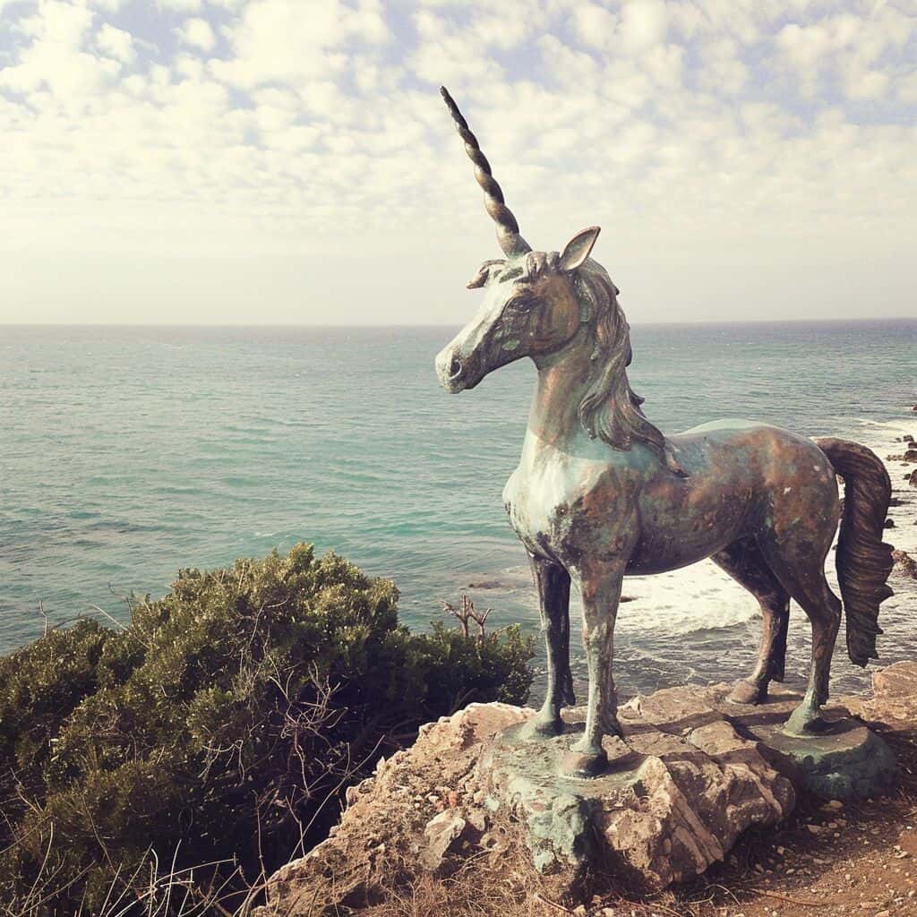 A sculpture of a unicorn by the sea
